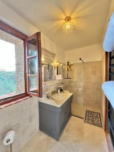 a bathroom with a sink and a shower at LA COLLINA DEI SAPORI Montepulciano in Montepulciano +36 photos
