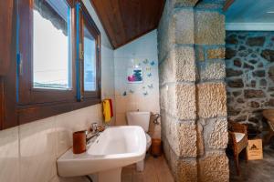 a bathroom with a sink and a toilet at Casa do Sarracas in Vilar de Perdizes