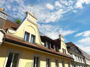 a building with a clock tower on top of it at Hotel Alpina Luzern in Lucerne +41 photos