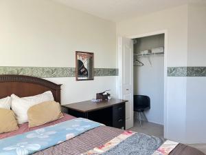 a bedroom with a bed and a desk in it at Hidden valley treehouse home! in Calgary
