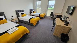 a hotel room with two beds and a television at MOSiR Rypin in Rypin