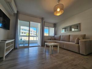 a living room with a couch and a table at The White Pearl Marbella in Marbella