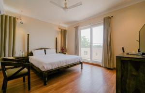 a bedroom with a bed and a large window at R41 - Boutique Hotel Vaishali Nagar Jaipur in Jaipur +63 photos
