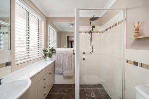 a bathroom with a shower and a sink at Luxury at Lagoon Estate in Nelson Bay +22 photos