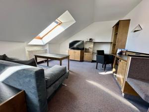 a living room with a couch and a table at Hotel Residenz in Bad Neustadt an der Saale