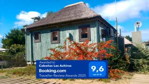 a small house with a sign in front of it at Cabañas Las Achiras in Punta Del Diablo
