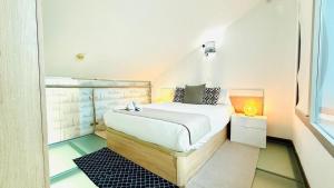 a small bedroom with a bed in a attic at Seasonal Living Lumen Triplex in Madrid