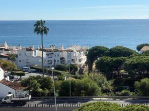 a view of a white house and the ocean at Studio La Calita in Mijas Costa