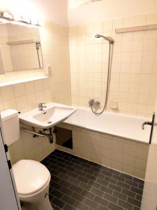 ein Badezimmer mit Toilette, Waschbecken und Dusche in der Unterkunft Bad Gastein Holiday Apartments in Bad Gastein