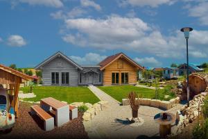 a house with a landscaping in front of it at Chalets Waldeck - Urlaub im Fränkischen Seenland und Altmühltal 