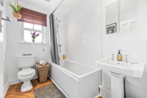 a white bathroom with a toilet and a sink at Deppers Bridge, 3 Bedroom Property  +46 photos