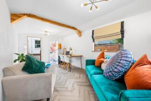 a living room with a green couch and a table at Deppers Bridge, 3 Bedroom Property 