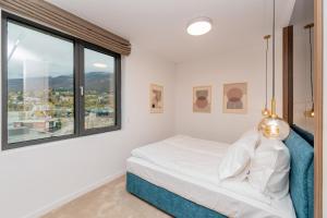 a bedroom with a bed and a large window at Novita Hotel in Sofia