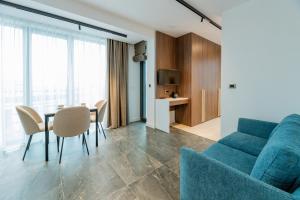 a living room with a blue couch and a table at Novita Hotel in Sofia