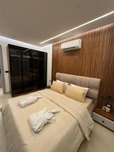 a bedroom with a large bed with towels on it at The View - Luxury One bedroom Apartment in Sharm El Sheikh +11 photos