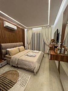 a bedroom with a large bed and a desk at The View - Luxury One bedroom Apartment in Sharm El Sheikh