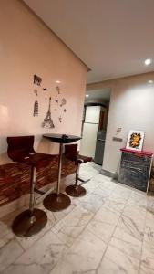 a dining room with a table and two chairs at Beautiful appartement with pool view in Mohammedia