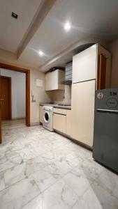 a kitchen with a refrigerator and a dishwasher at Beautiful appartement with pool view in Mohammedia