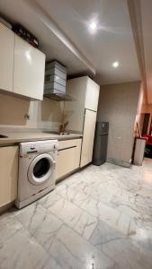 a kitchen with a washing machine in a room at Beautiful appartement with pool view in Mohammedia