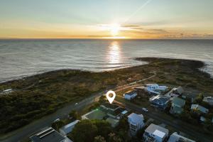 an aerial view of a beach with houses and the ocean at The Beach House Bawley Point - near Bawley Beach in Bawley Point