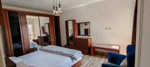 a bedroom with a bed and a mirror and a chair at Al Rehab city, Avenue Mall group129 bulding7 5th, CASA MIA in New cairo