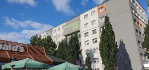 a building with a sign on the side of it at VESTA Apartamenty P23 in Szczecin
