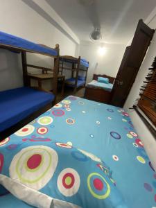 a bedroom with a bed with a colorful comforter at Casa Bora Bora in Sopetrán
