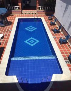 a blue tile swimming pool on a tile floor at Casa Bora Bora in Sopetrán +5 photos
