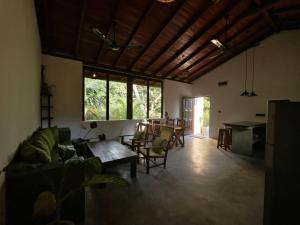 a living room with a couch and a table at Asoka's Place in Unawatuna