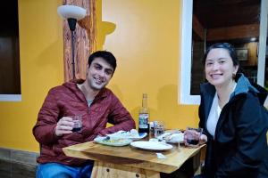 a man and a woman sitting at a table at Hiwang Native House Inn & Viewdeck in Banaue +42 photos