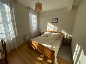 Postel nebo postele na pokoji v ubytování Les Iris