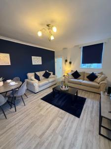 a living room with two couches and a table at Rochester House in Middlesbrough