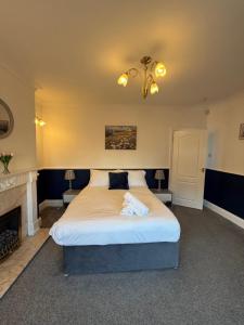 a bedroom with a large bed and a fireplace at Rochester House in Middlesbrough