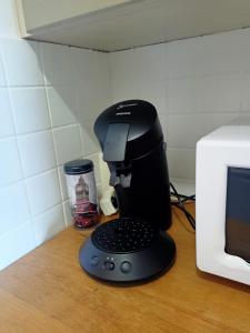 a coffee maker sitting on a counter next to a microwave at Studio lumineux et cosy avec vue montagne 7è étage in Superdevoluy