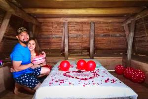 a man and a woman standing next to a birthday cake at Hiwang Native House Inn & Viewdeck in Banaue