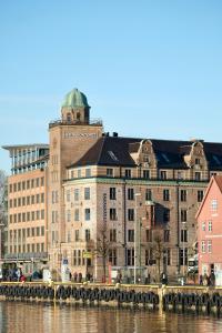 a group of buildings next to a body of water at Home Hotel Havnekontoret in Bergen