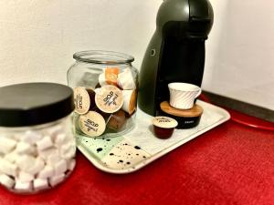 a jar of cookies and a coffee maker on a table at Ferienwohnung Lona in Bad Reichenhall