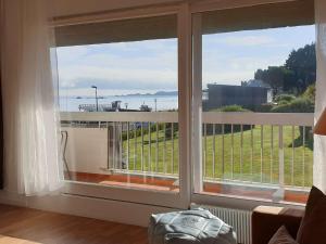 a room with a window with a view of the ocean at Appartement 3* avec terrasse et parking, à 2 pas de la plage de Trestraou à Perros-Guirec - FR-1-368-244 in Perros-Guirec