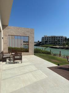 two benches on a patio with a view of the water at Hawana Salalah Resort - FV 5 in Salalah