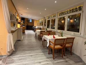 a dining room with tables and chairs in a restaurant at Hotel-Restaurant Christine in Lübz