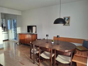 a dining room with a table and chairs at Villa Caslano in Caslano