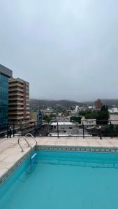 a swimming pool on the roof of a building at Departamento Orlando, zona centro in Villa Carlos Paz +10 photos
