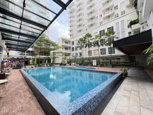 a large swimming pool in the middle of a building at Cozy Bogor Icon Studio Apt bogor W Pool in Kedunghalang