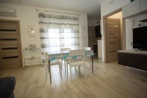 a dining room table and chairs in a room at Dimora Patio in Policoro +7 photos