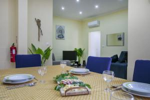 a table with plates and wine glasses on it at Furnas Cozy Inn in Furnas