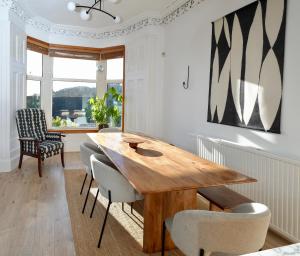 a dining room with a wooden table and chairs at Carmona Bank in Dunoon