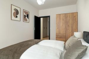 a bedroom with a bed and a wooden door at Luxury Apartment with Parking & Terrace Remote Work by Renters Prestige in Poznań