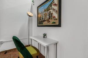 a room with a table and a painting on the wall at Lovely Stay Arucas in Arucas +17 photos
