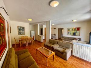 a living room with a couch and a table at 4-Bedroom chalet for Ski and Summer in Kfardebian