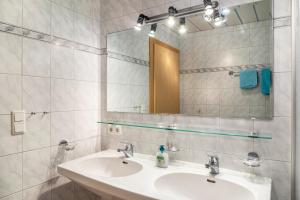 a bathroom with a sink and a mirror at Wohlfühlnest in Nauders +18 photos